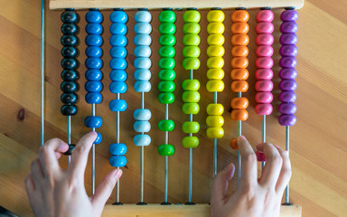Hands Counting On Colorful Bead Abacus