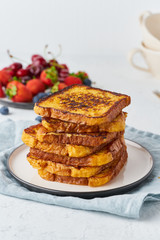 French toasts with berries, brioche breakfast, white background, vertical closeup