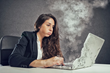 Woman stressed by overwork with the laptop melting