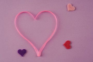 pink ribbon heart on purple background