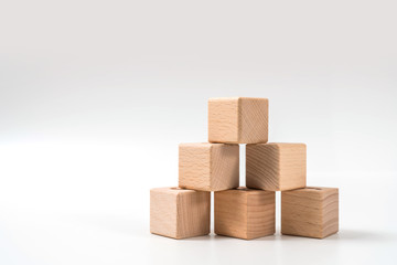 wood cube arrange in pyramid shape ,business concept