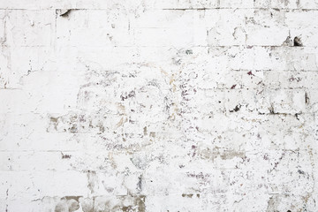 abstract background of wall of concrete blocks painted white with translucent old paint