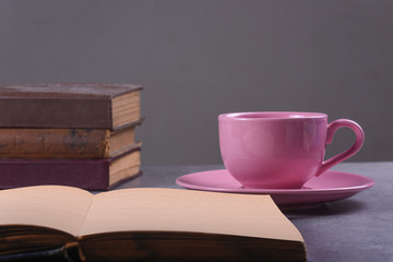 Book and Cup of Coffee on Stone Background