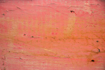 Pink painted worn metal surface