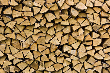 chopped firewood stacked in a woodpile