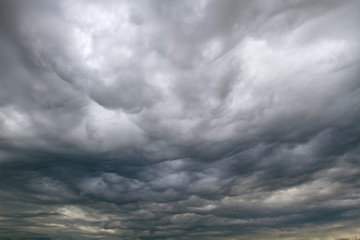 Background of dramatic sky with dark clouds. Sky before a thunder-storm.