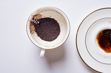 divination on coffee grounds in white cup and plate around white