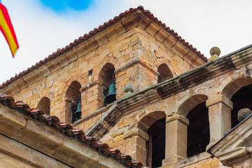 Obraz premium Bell tower in the tower of the Collegiate Church of Santillana del Mar (Cantabria - Spain). Medieval village. Romanesque art of the twelfth century. Santiago's road