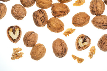Nuts (whole and open) falling. Isolated on white background.