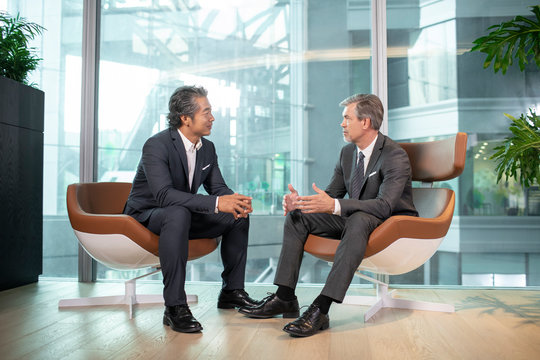 Two businessmen talking in office