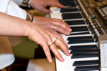Close up of musician hands classic piano playing. Musician hands. Scene of pianist hands. Male musician playing midi keyboard synthesizer in recording studio. Pianist's hands playing the melody .