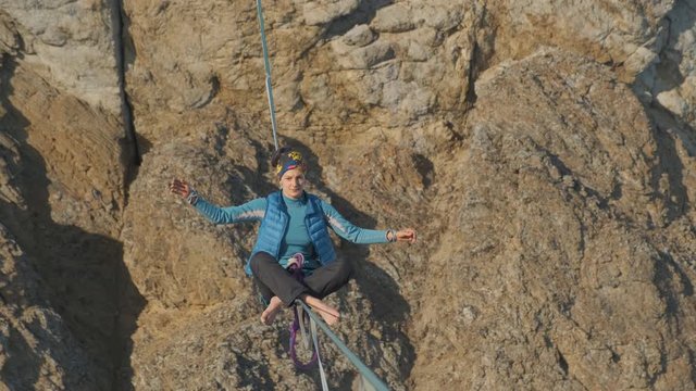 Yoga on a slackline stretched at a height.