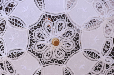 Vintage white umbrella with decorative ornaments and pattern