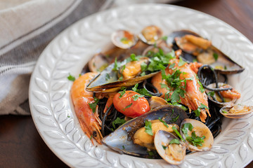 A plate of black spaghetti and seafood.