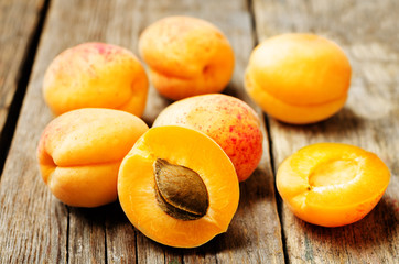 apricots with slices on a wooden background