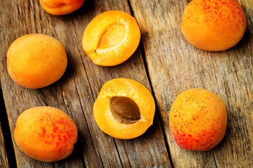 apricots with slices on a wooden background