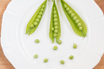 green peas on a white plate