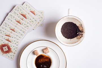 spelling cards and cup with  coffee grounds  around white