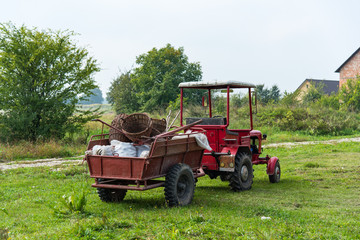 Tractor with full trailer of harvest. Harvesting, autumn