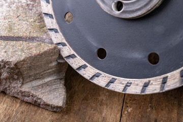 Stone cutting with a diamond disc mounted in a grinder. Work in a stone workshop.