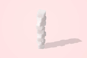 Stack of sugar cubes over pink background