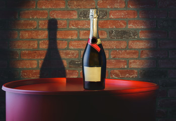Bottle of champagne on a red barrel