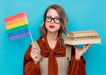 Young woman with books and LGBT flag