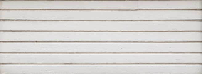 Full frame background of a clean wood board wall painted in white. Copy space.