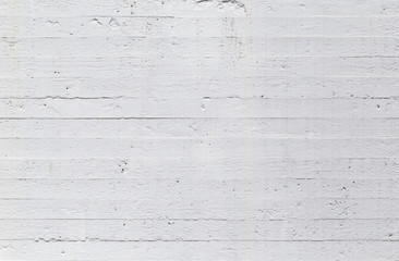 High resolution full frame texture background of a plastered, painted, uneven and a bit dirty white concrete wall.