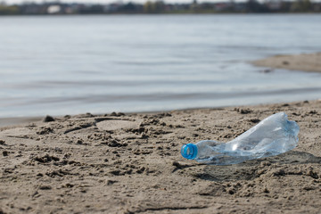 Fototapeta na wymiar plastic trash bottle on beach. Pollution concept photo