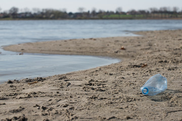 plastic trash bottle on beach. Pollution concept photo