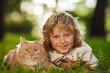 Little curly boy with a redhead cat