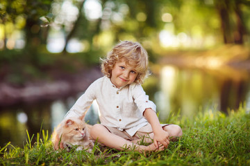 Little curly boy with a redhead cat
