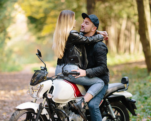 Obraz na płótnie Canvas young couple on motorcycle laugh