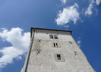 Fototapeta na wymiar Ancient tower in Zagreb city high in the sky and white clouds 