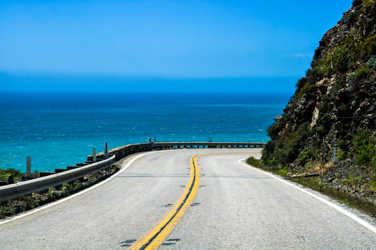 California Highway Curves Around Cliff with Ocean in Background