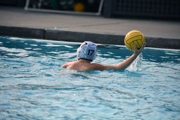Youth Water Polo Player Throwing Ball