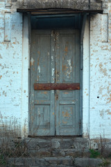 The boarded up door of the facade wall of the nineteenth century building.