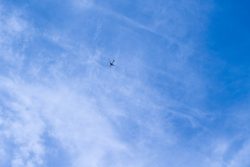 Airplane flying high in the sky on summer
