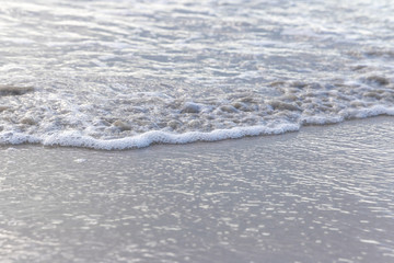 Smooth wave at white sand beach.
