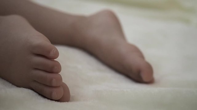 close up foot  of sleeping kid moving a little bit. Concept of love family and parenthood relation