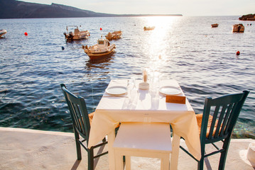 romantic dinner table by the sea Santorini, Greece