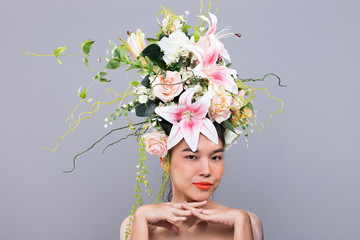 Crown of Fresh Flower as Queen on Asian Very Beautiful Woman Fashion Posing express for Advertising Campaign Lipstick, cosmetic, perfume. Studio lighting isolated gray background copy space
