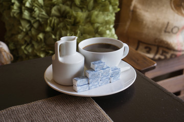 Coffee with creamer and a lot of sugar cubes