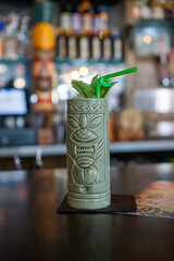 Tiki drink in tiki mug at tiki bar