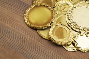 Golden medals on wooden table