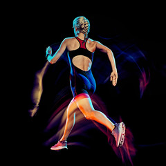 one caucasian woman triathlon triathlete runner running joogger jogging studio shot isolated on black background with light painting effect