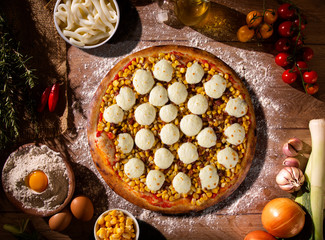 Pizza corn and cheese on wood background. Top view, close up. Traditional Brazilian Pizza.
