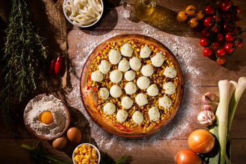 Pizza corn and cheese on wood background. Top view, close up. Traditional Brazilian Pizza.