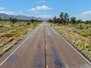 Aerial view of endless desert road in Joshua Tree Park. USA. Long straight tarmac road heading into the desert to the direction of Arizona.
